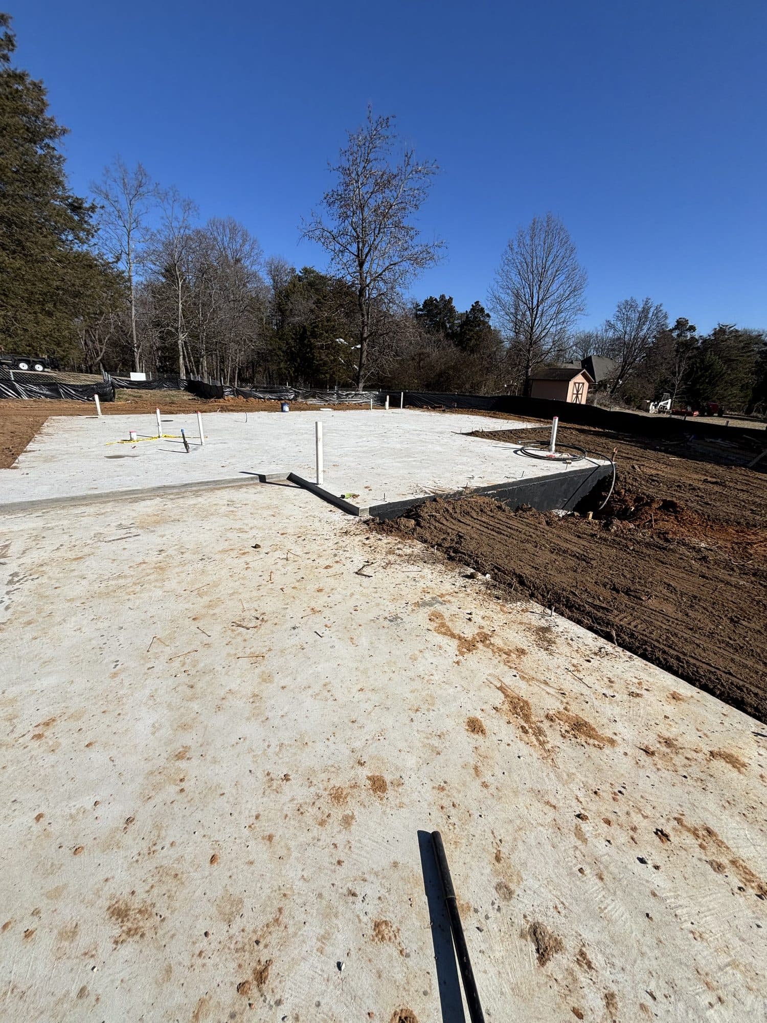 Finished concrete foundation slab on cleared lot. Concrete project by Potts Brothers Construction, Arlington & Northern Virginia