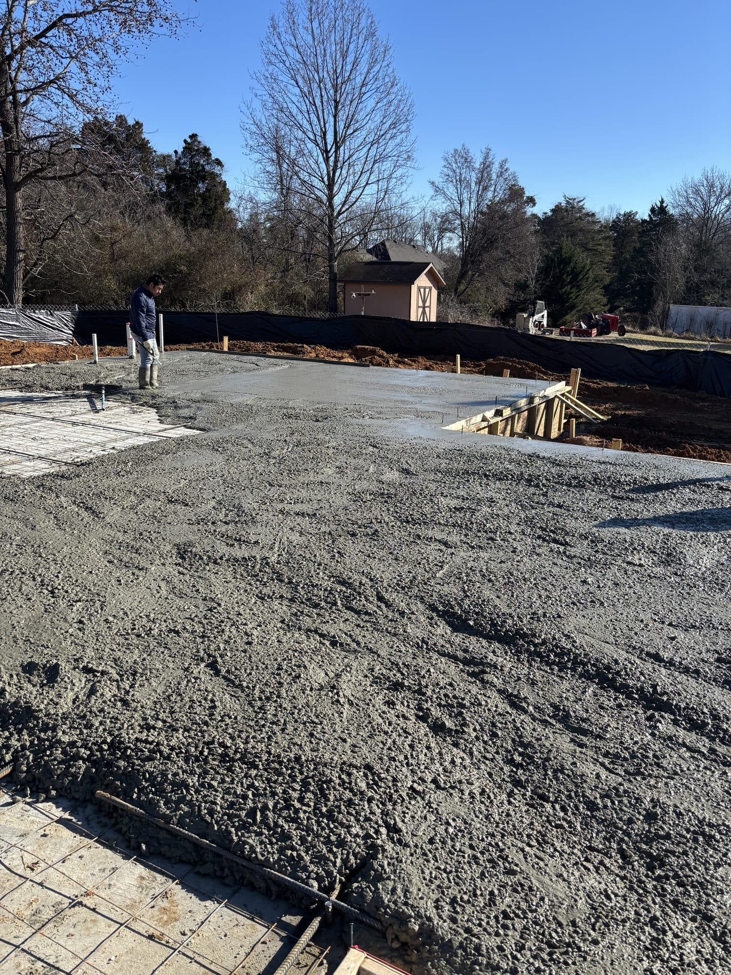 Freshly poured concrete slab being placed on site. Concrete project by Potts Brothers Construction, Arlington & Northern Virginia