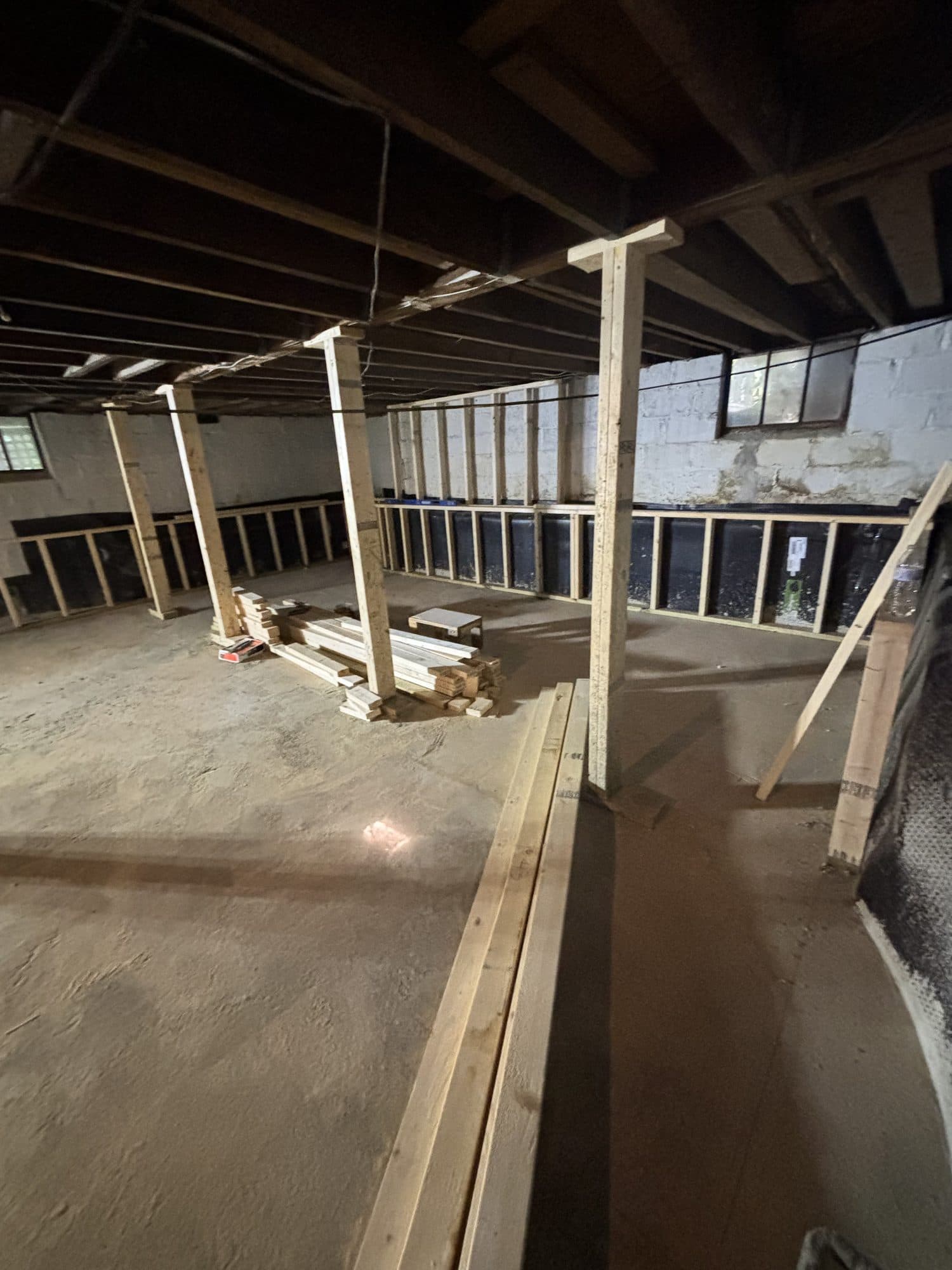 Basement moisture protection with perimeter drainage and new slab. Foundation project by Potts Brothers Construction, Arlington & Northern Virginia