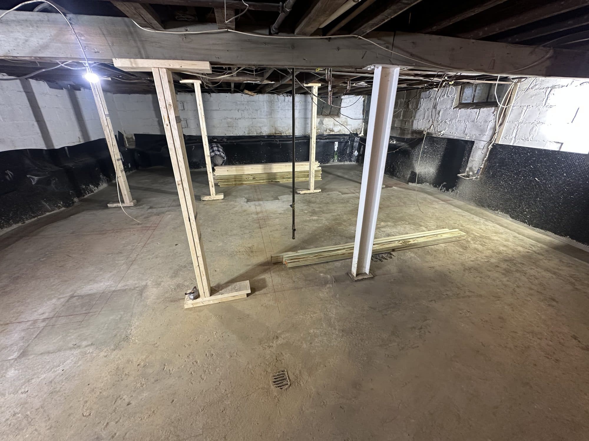 Renovated basement with fresh slab and support columns. Foundation project by Potts Brothers Construction, Arlington & Northern Virginia