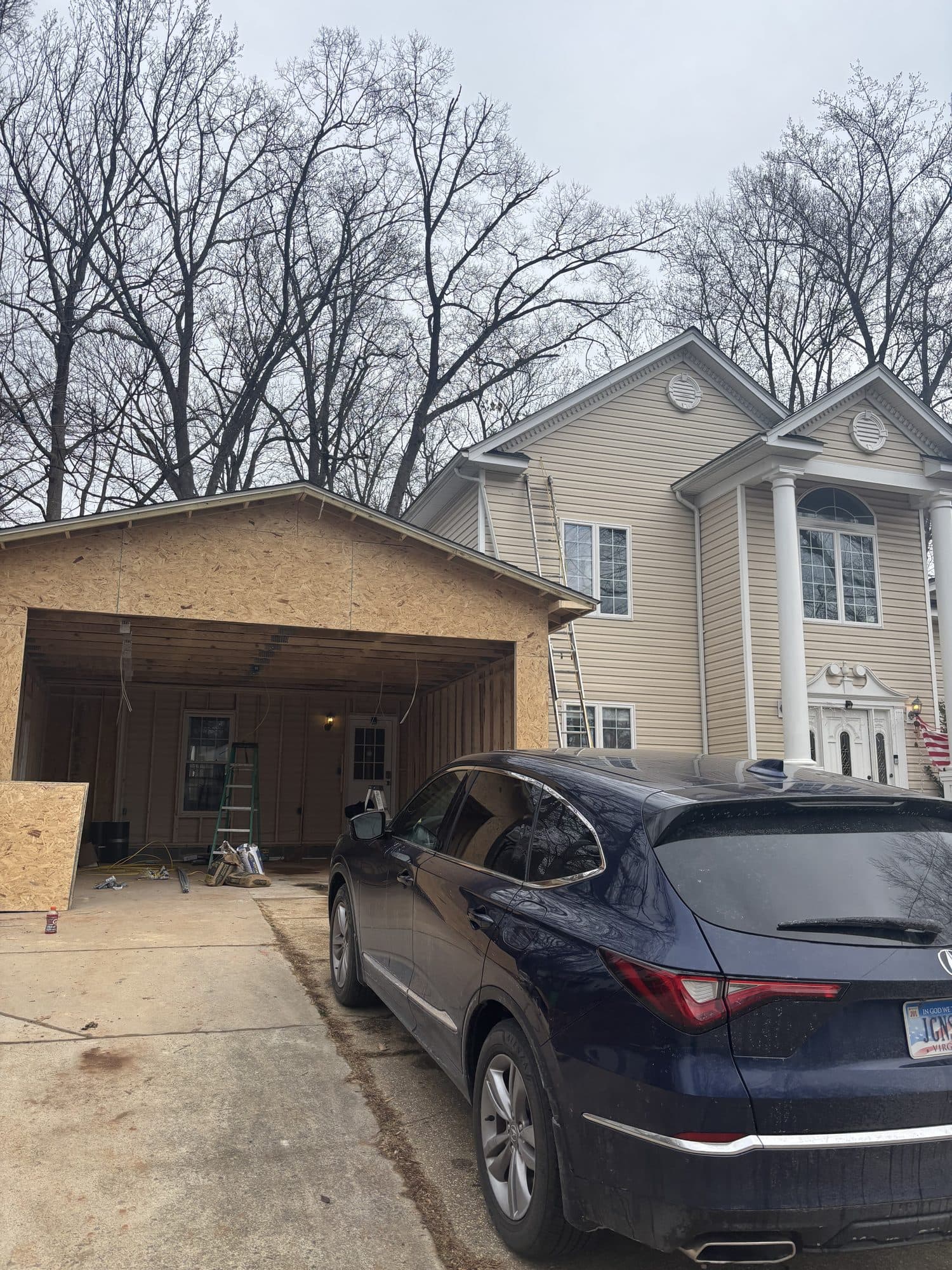 Detached garage framing beside two-story home. Garage project by Potts Brothers Construction, Arlington & Northern Virginia