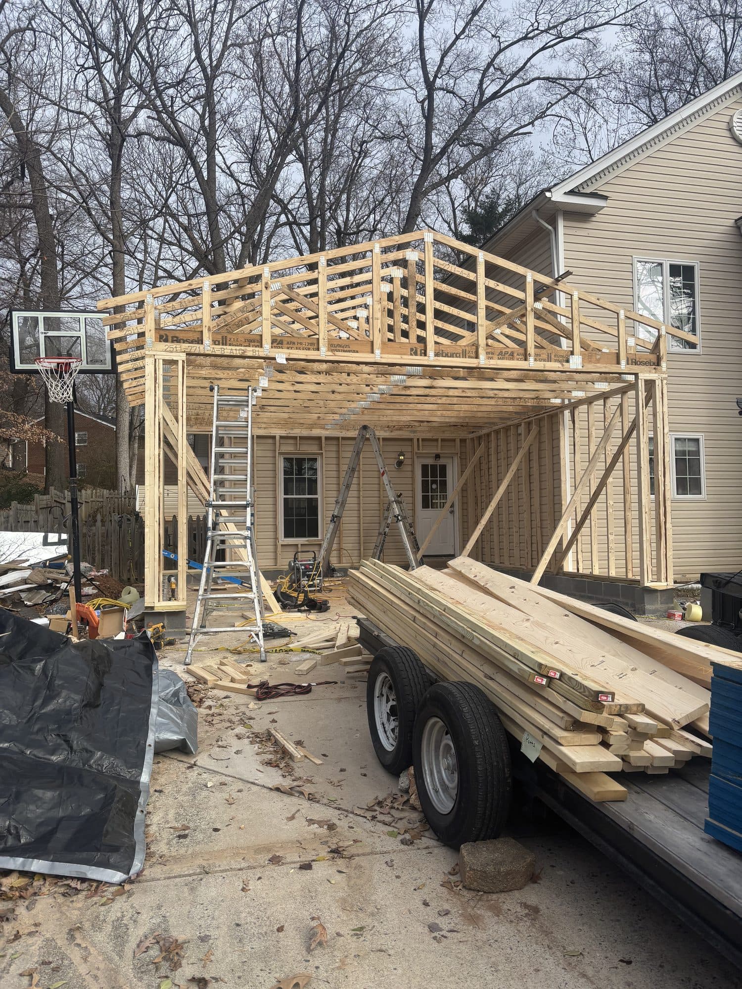 Second-story garage addition framing over driveway. Garage project by Potts Brothers Construction, Arlington & Northern Virginia