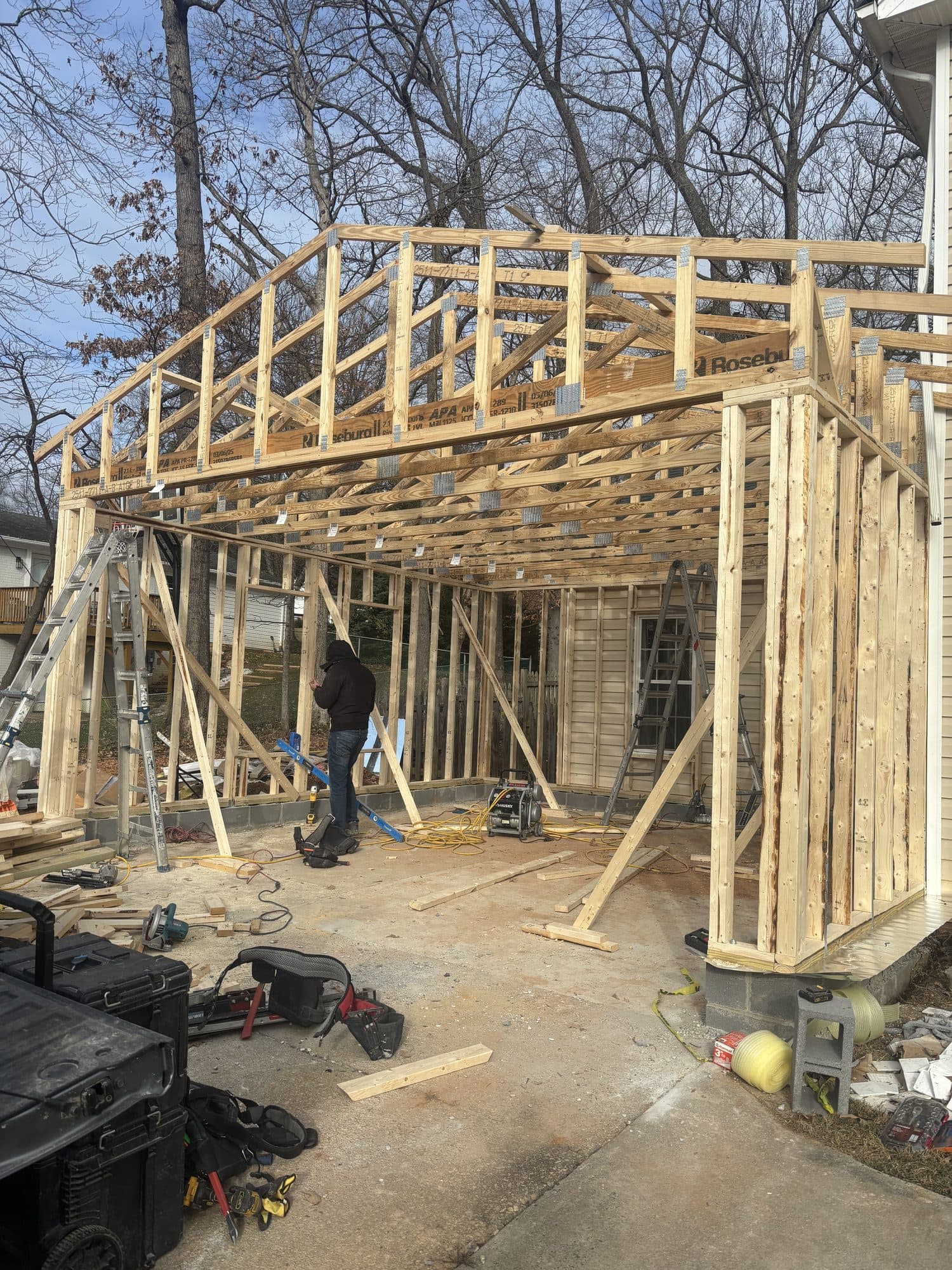 Two-story garage addition framing with workers. Garage project by Potts Brothers Construction, Arlington & Northern Virginia