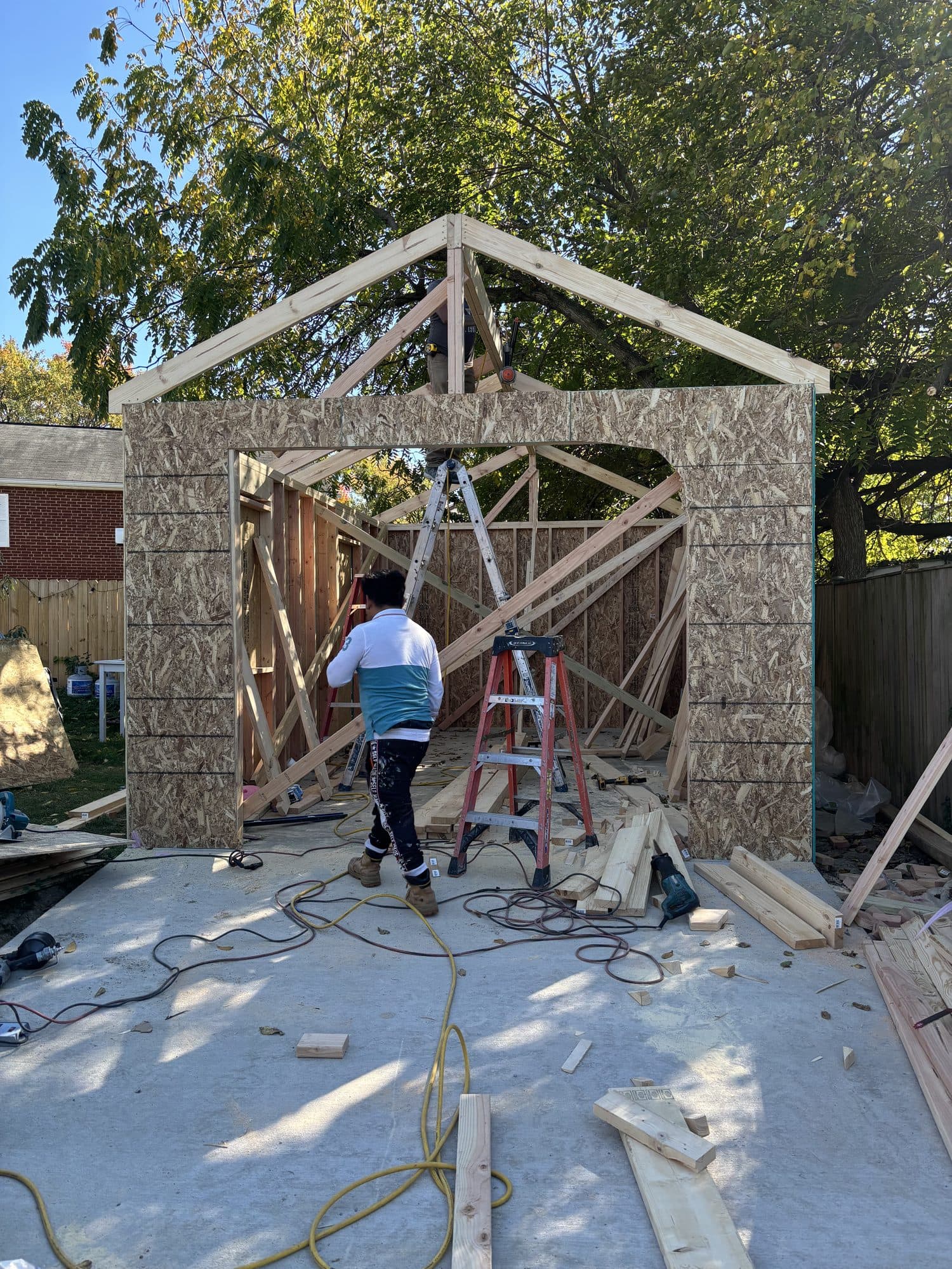 Wood-framed detached garage under construction with gable trusses. Garage project by Potts Brothers Construction, Arlington & Northern Virginia