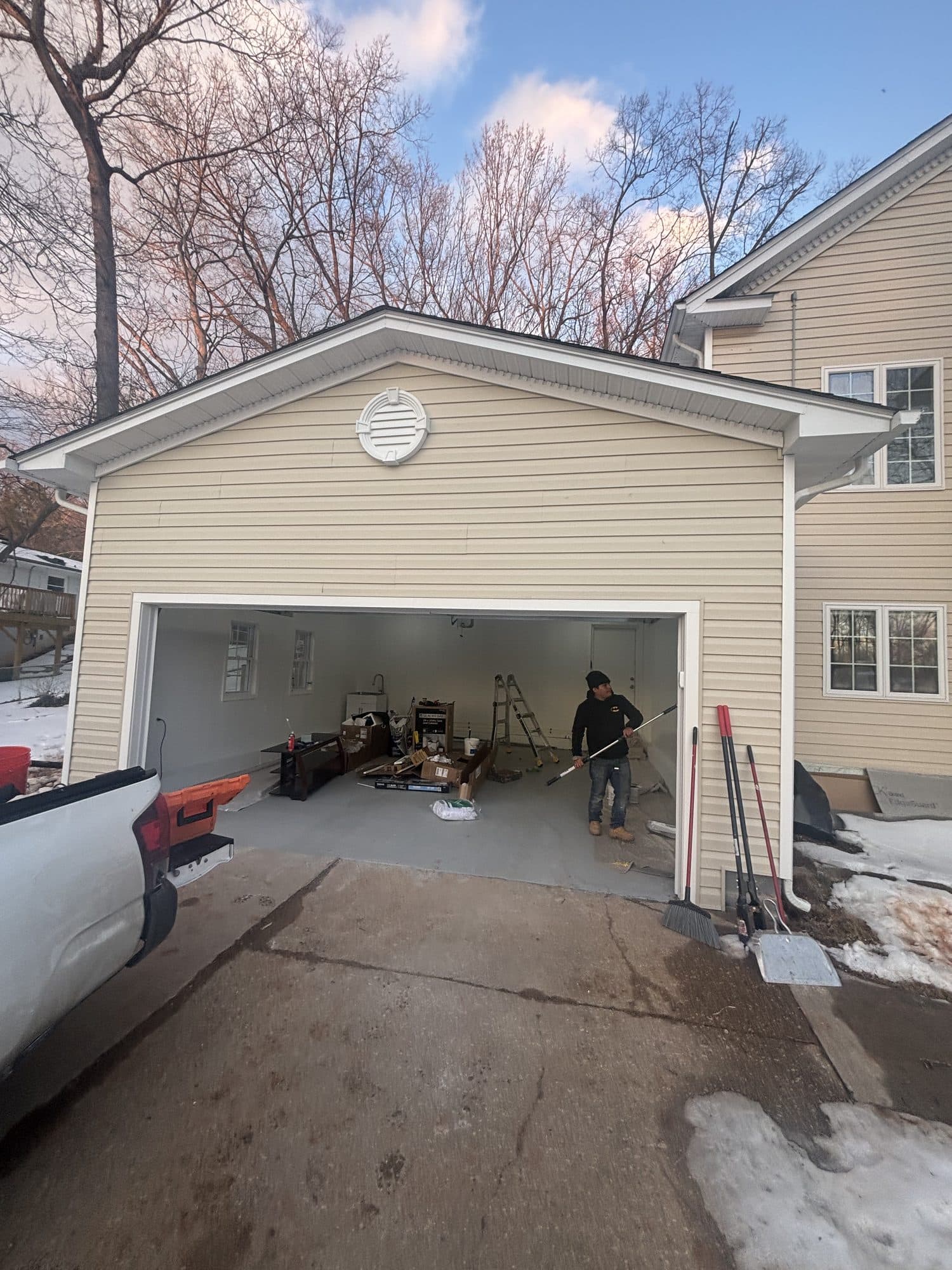 Attached garage interior remodel with open door. Garage project by Potts Brothers Construction, Arlington & Northern Virginia